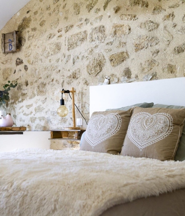 a bedroom with a large bed and a large window