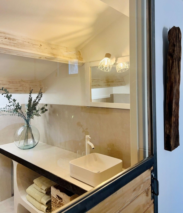 A rustic and bright bathroom with a sink and towels.