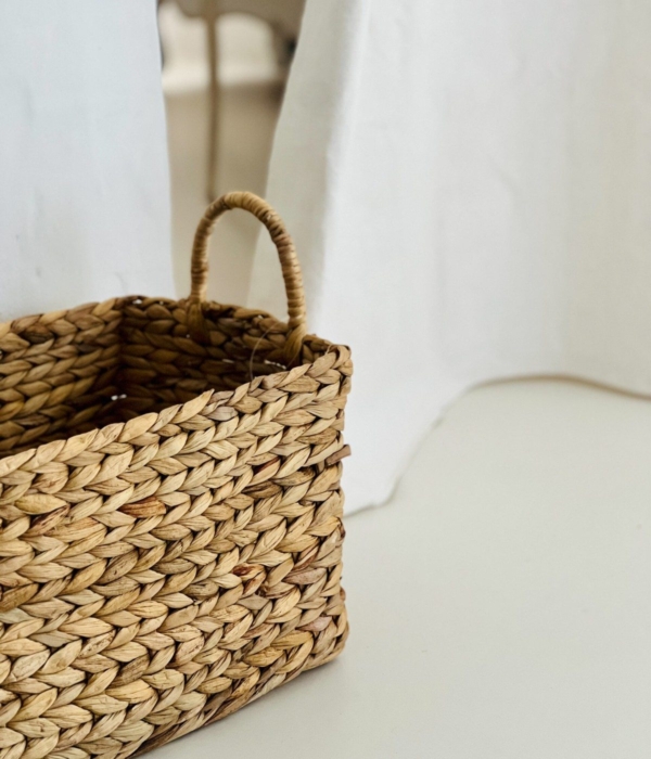 A natural wicker basket in a bright and uncluttered interior.