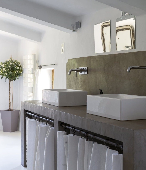 a bathroom with two sinks and a mirror