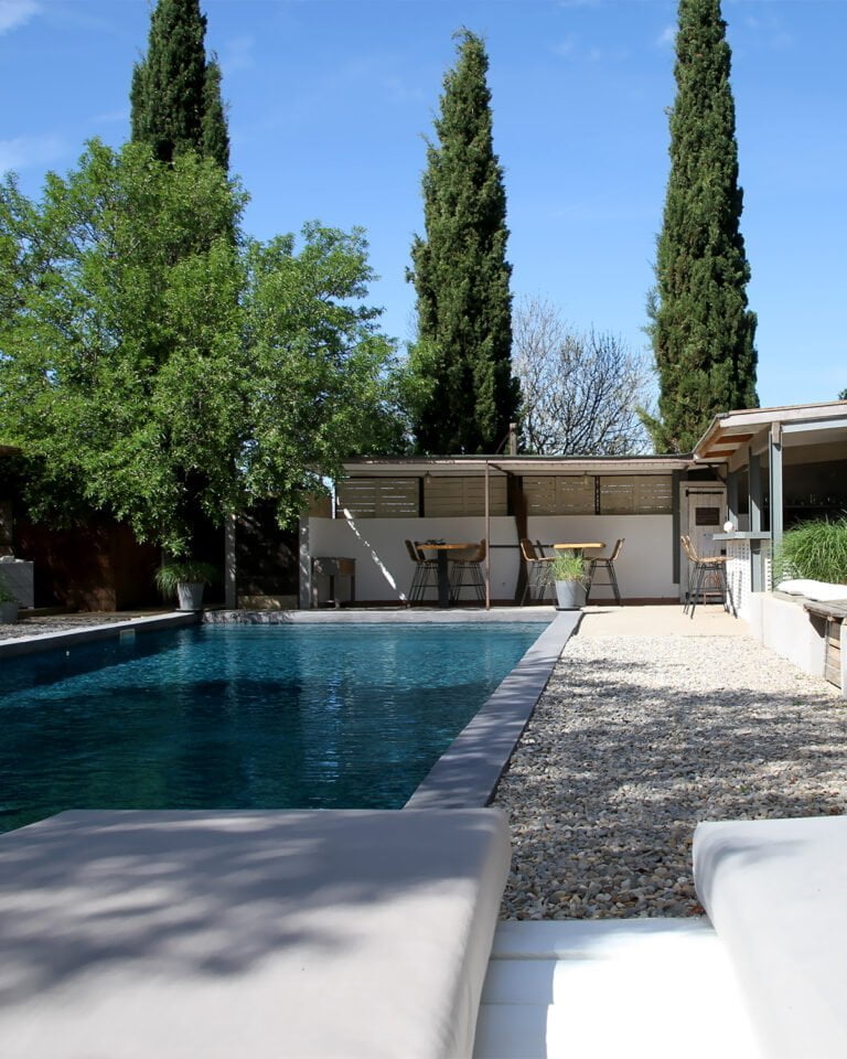 a large swimming pool with a tree in the middle.