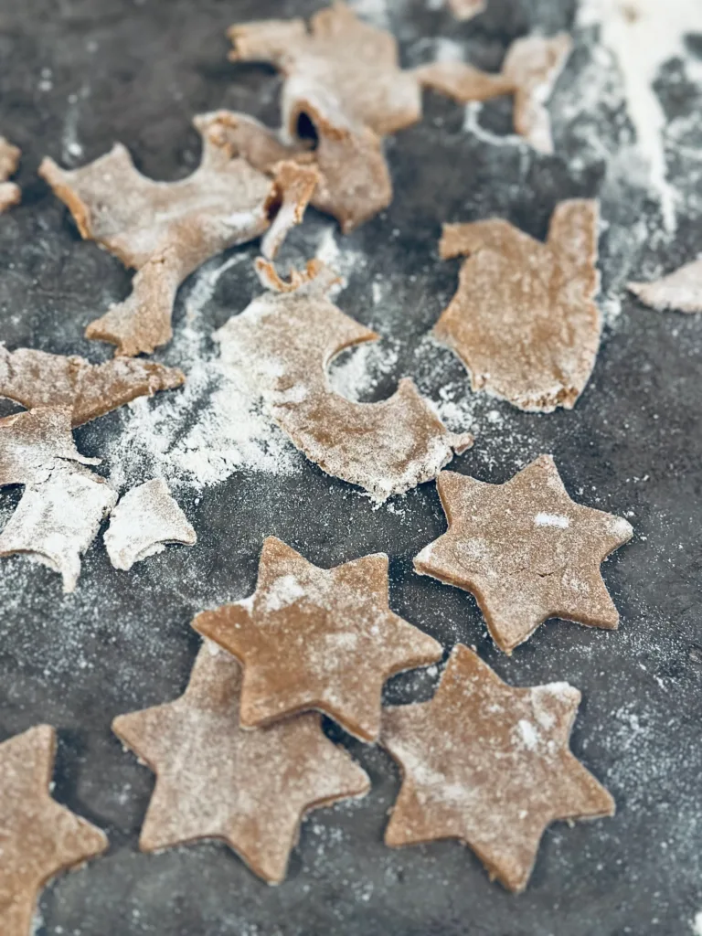 Star-shaped biscuits, covered in flour, ready for Christmas.