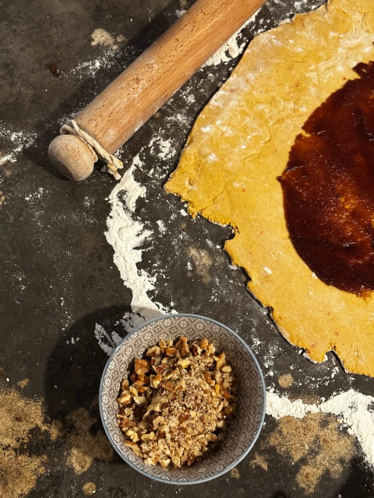 Pie dough, nut filling and rolling on a floured surface.