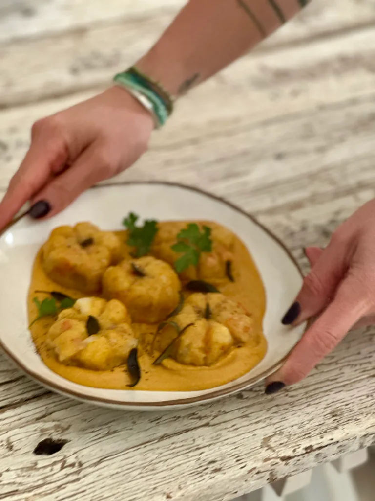 Un délicieux plat de crevettes au curry sur une assiette blanche, décoré de persil frais.