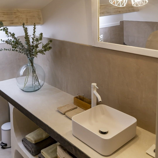 a white vase sitting on a white counter