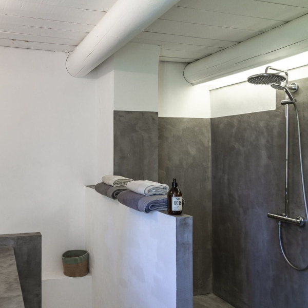 a bathroom with sink, toilet and shower